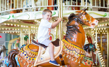 Kid on carousel at Memorial City Mall.